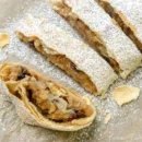 omas-apfelstrudel Austrian Apple Strudel Slice (Apfelstrudel) - Authentic pastry with flaky layers, filled with apples, raisins, and cinnamon