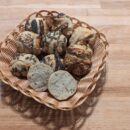 This picture showes franconia buns with different sort of seeds in a basket such as sesame, sunflower, pumpkin and poppy seeds