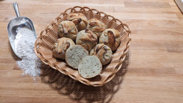 this picture showes multiple plain franconia buns in a basket