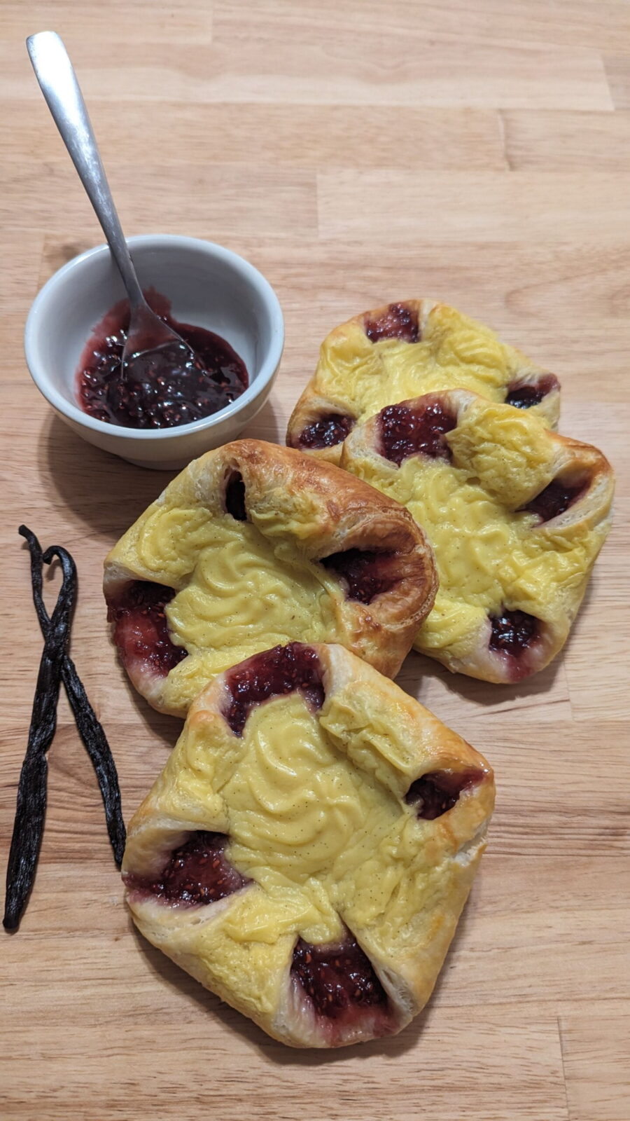 sweet vanilla raspberry danish This picture shows 4 sweet vanilla raspberry danish with 2 vanilla beans