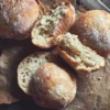 This image shows our sourdough ciabatta buns on a cutting board, show casing the nice texture of the bun