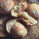 This image shows our sourdough ciabatta buns on a cutting board, show casing the nice texture of the bun
