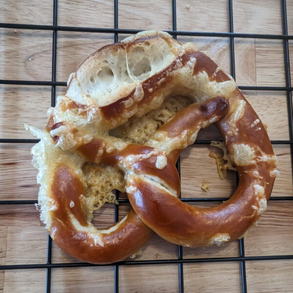 bretzel-emmentaler image of the original bavarian bretzel, topped with Emmental cheese from Swiss, even our photographer could not resist this delicious treat