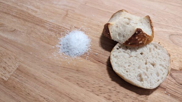 this picture showes a bretzel bun cut open on a table